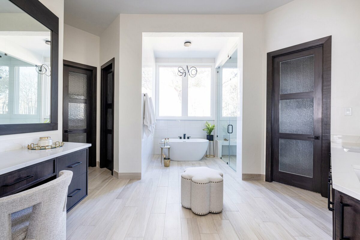 Signature Home Services master bathroom remodel with dark stained wood and white soaking tub next to steam shower