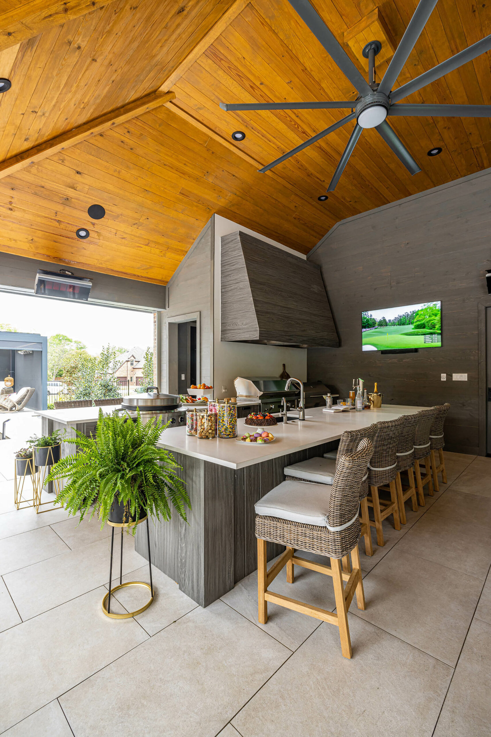 Birkenfeld_Pool cabana full kitchen with custom hood and four grills and custom ceiling fan and custom cabinetry in Keller Texas