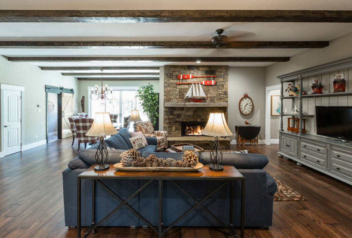 Signature Home Services whole home remodel featuring living room with farmhouse style including sliding barn door and rebuilt fireplace