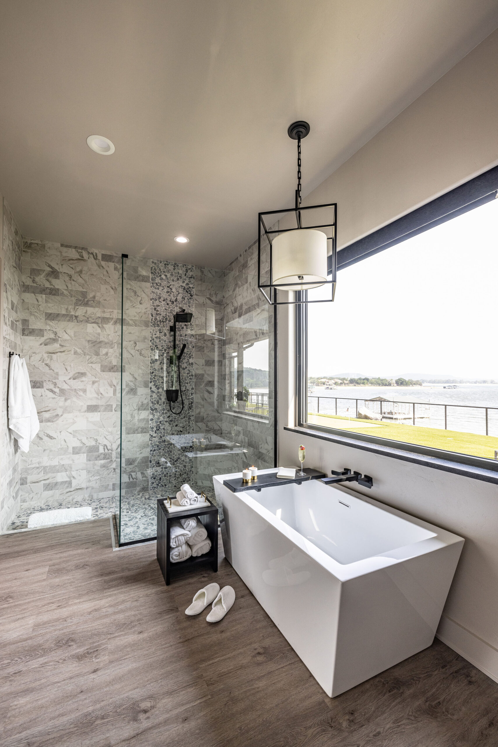 Lake house_Full bathroom with light fixture standing tub and custom tile detail in second home vacation property in Possum Kingdom Lake Texas