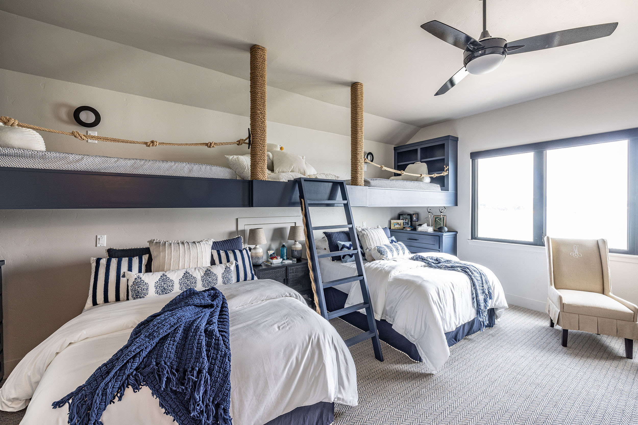 Lake house_Grandkids room with loft bed and overstuffed fluffy bedding and play area in nautical theme second home vacation property in Possum Kingdom Lake Texas