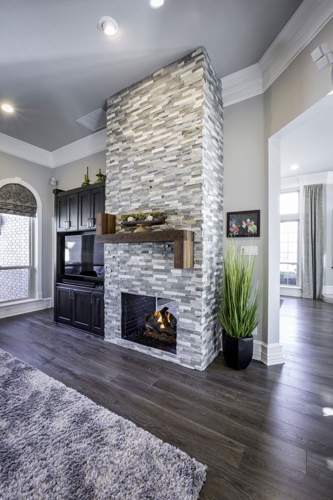 Signature Home Services custom rebuilt fireplace with mantle of natural wood and stone chimney