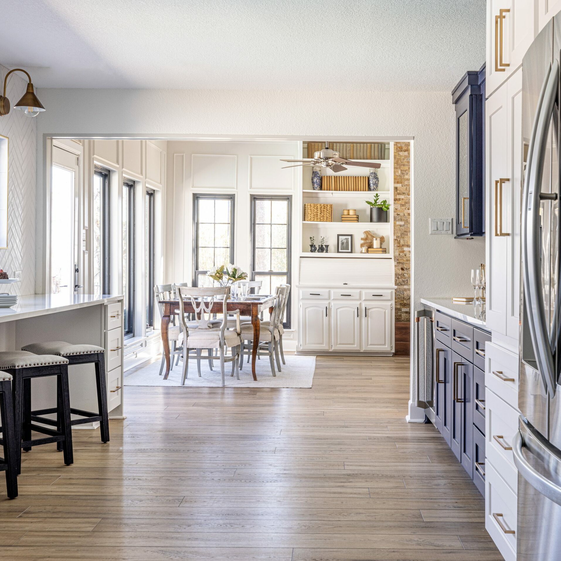 Guerin_Kitchen renovation with custom cabinetry and adjacent dining area and large fridge and focal blue paint cabinets in Trophy Club Texas